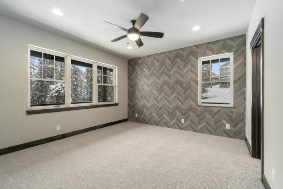 Primary bedroom with accent wall in Moosehorn Uphill Cabin