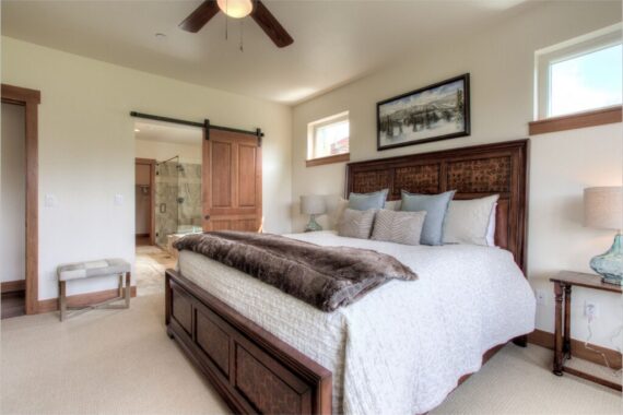 Furnished primary bedroom in model home at Rendezvous Bighorn Cabin