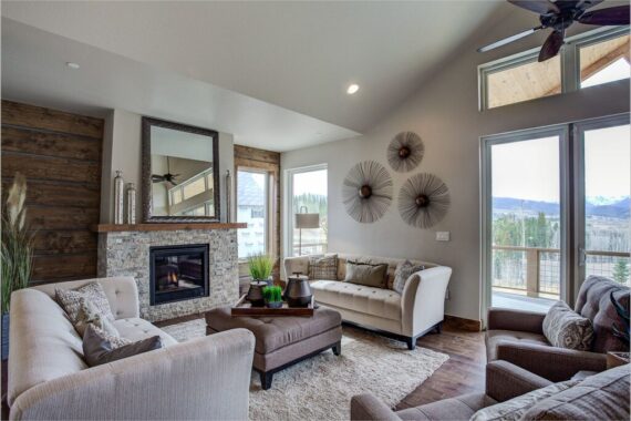 Furnished living room with fire place in model home at Rendezvous Bighorn Cabin II