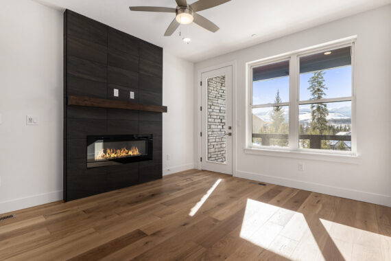 Modern living room with fireplace and large windows