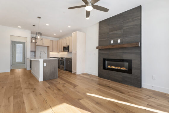 Modern kitchen and living room with fireplace and island