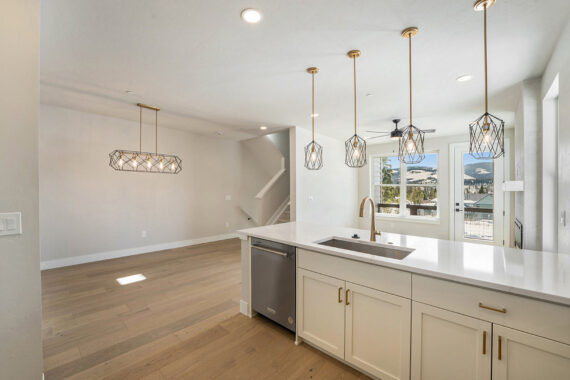 Modern kitchen and dining area with stylish lighting fixtures