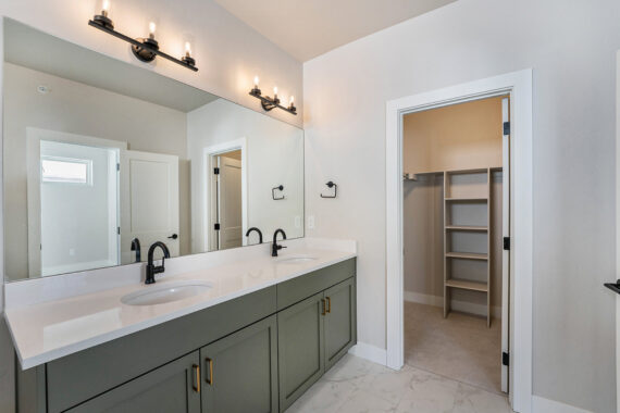 Bathroom with double sink vanity and walk-in closet