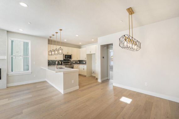 Modern kitchen with wooden floors and pendant lights