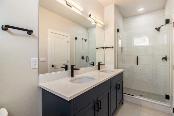 Modern bathroom with double sink vanity and glass shower