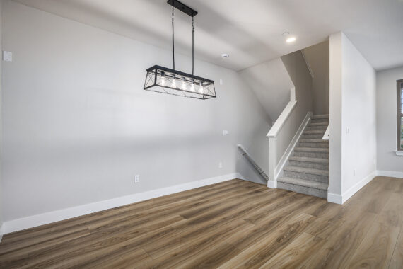 Empty room with wood floor and modern lighting fixture