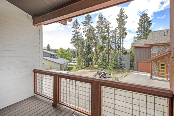 View from a balcony, overlooking trees and houses.