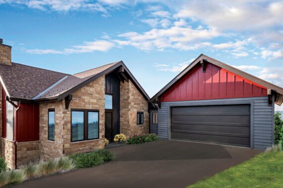 House with stone and red siding, garage, mountain backdrop