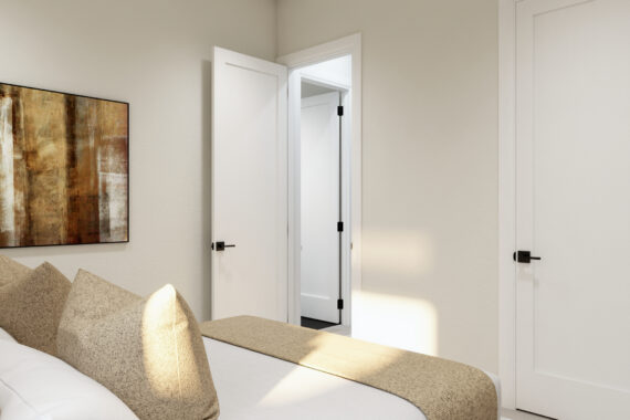 Bedroom with beige bedding and abstract wall art