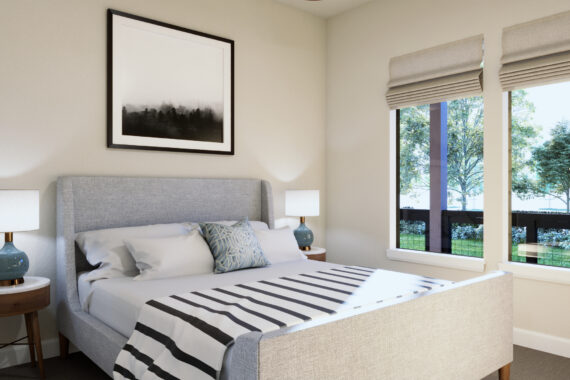 Modern bedroom with a striped blanket and framed art