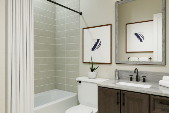 Bathroom with bathtub, framed art, and large mirror